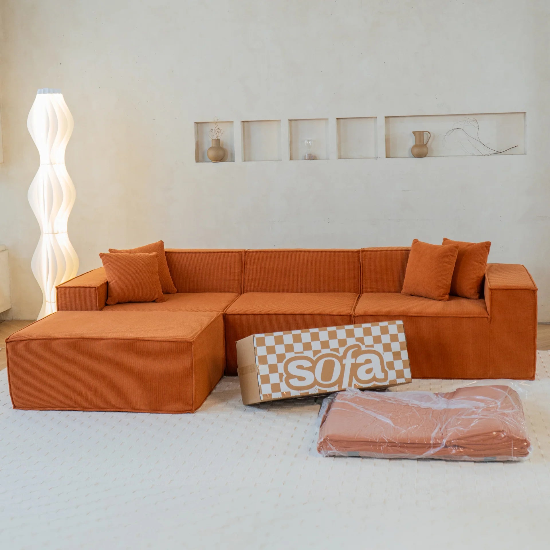 <tc>Sofa na Caixa</tc>  <tc>Pelion</tc> 3 lugares + 1 espreguiçadeira em Boucle - Laranja